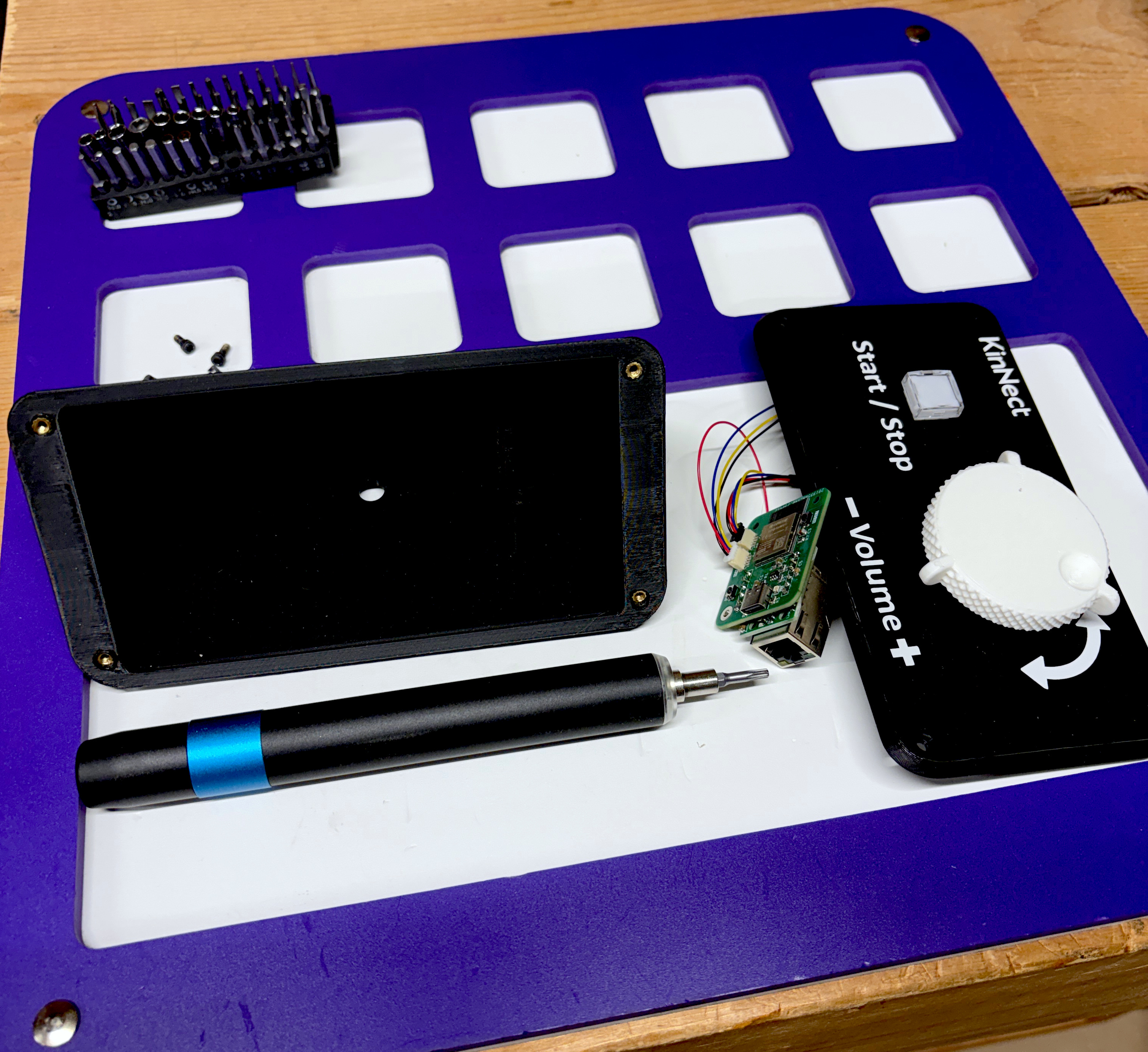 KinNect unit components staged mid-assembly